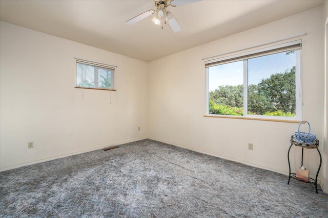 carpeted spare room with ceiling fan