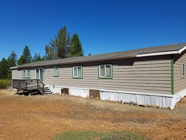 back of property featuring a wooden deck