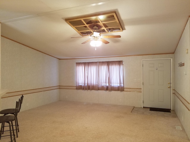 interior space with carpet and ceiling fan