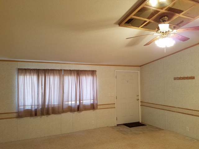 unfurnished room featuring crown molding, ceiling fan, and carpet floors