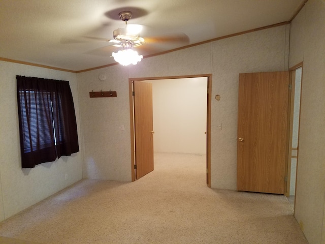 unfurnished room featuring carpet, ornamental molding, and ceiling fan