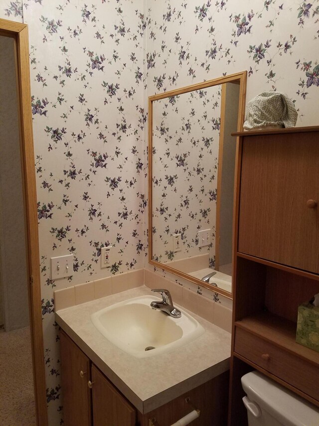 bathroom with toilet and vanity