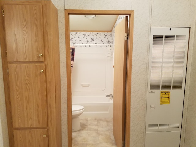 bathroom with shower / bathtub combination and toilet