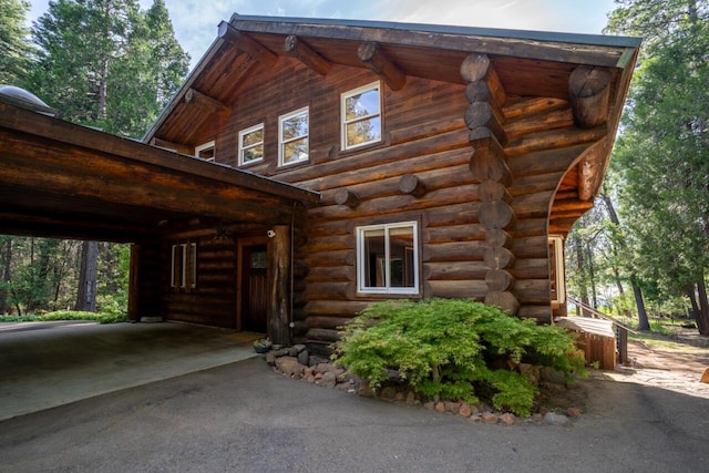 view of side of property with a carport