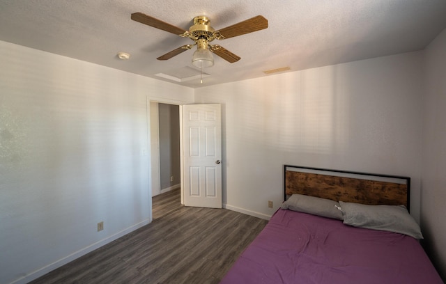 bedroom with dark hardwood / wood-style flooring, a textured ceiling, and ceiling fan