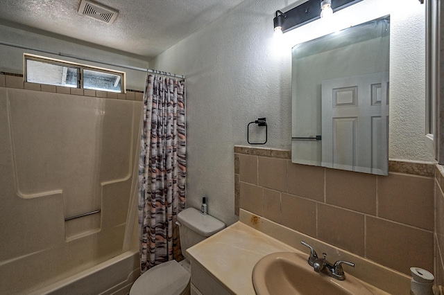 full bathroom featuring toilet, shower / tub combo, a textured ceiling, vanity, and backsplash