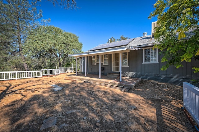 view of front of house with solar panels and a porch