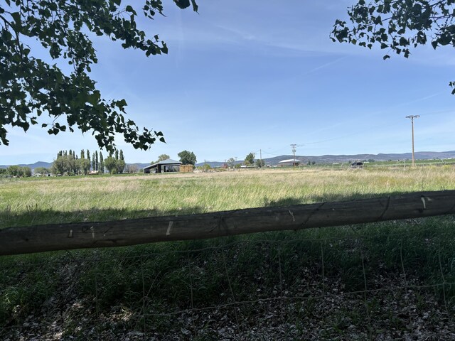 view of yard with a rural view