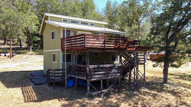 rear view of property with a wooden deck