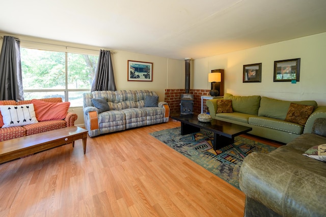 living room featuring wood-type flooring and a wood stove