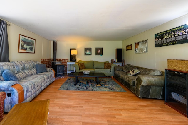 living room with light hardwood / wood-style flooring and a wood stove