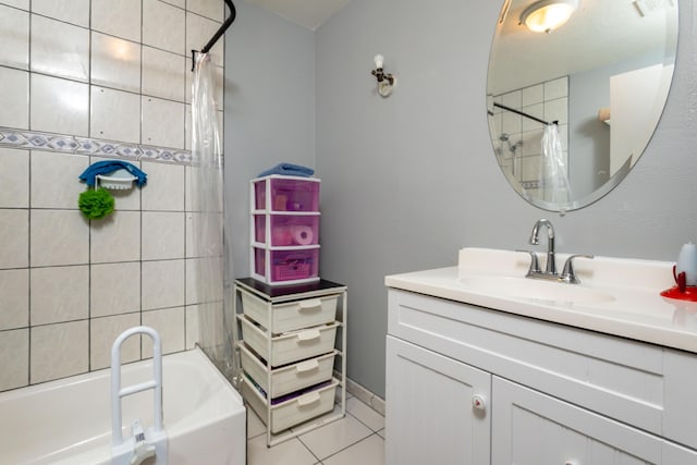 bathroom featuring tile patterned flooring, vanity, and shower / bath combo