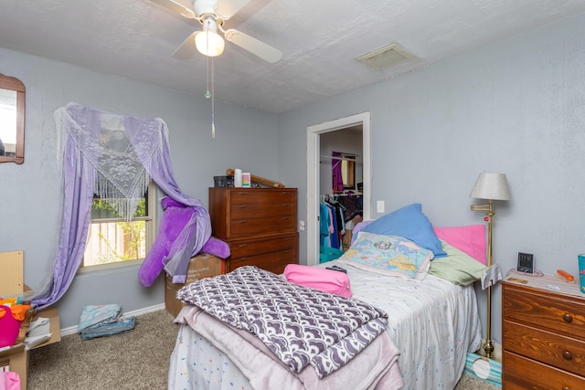 bedroom with ceiling fan, a closet, and carpet