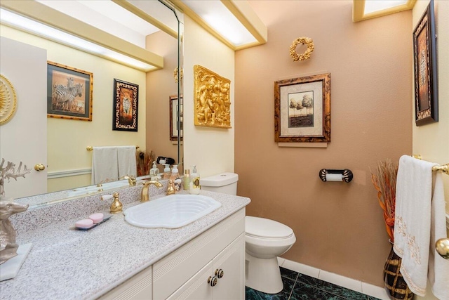 bathroom featuring tile patterned flooring, vanity, and toilet