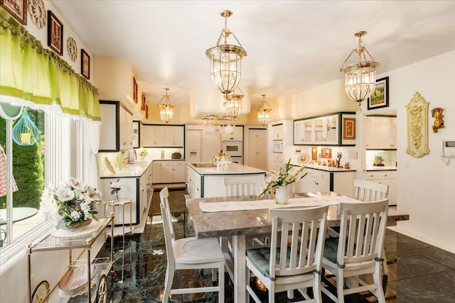 dining space with a notable chandelier and sink