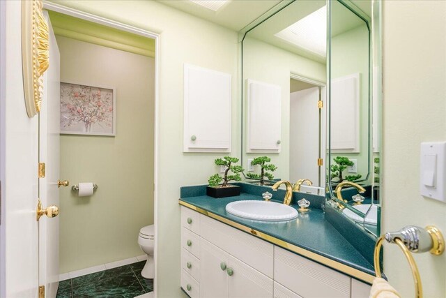 bathroom with vanity and toilet