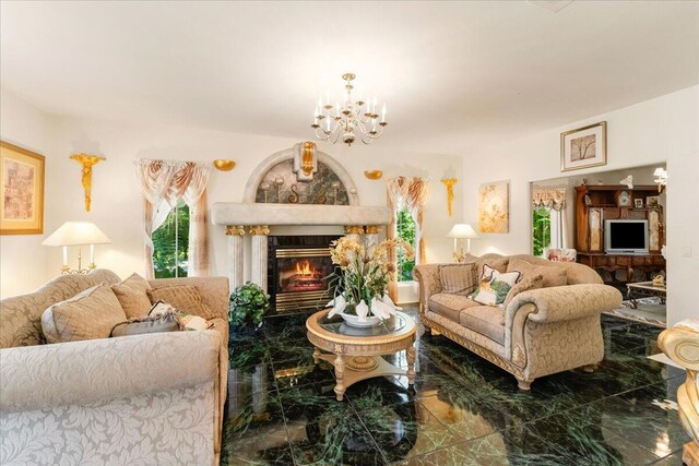 living room with a fireplace and an inviting chandelier