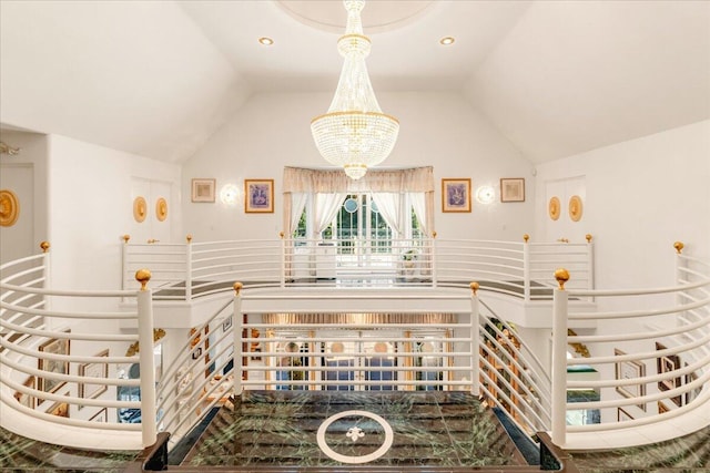 stairway featuring a notable chandelier and high vaulted ceiling