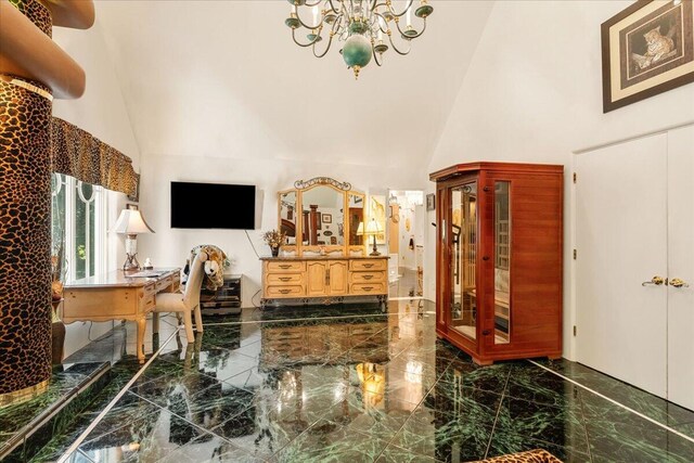 interior space with a towering ceiling and an inviting chandelier