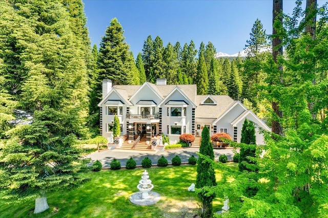 rear view of house featuring a yard and a patio