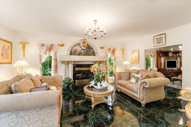 living room with a tile fireplace and a chandelier