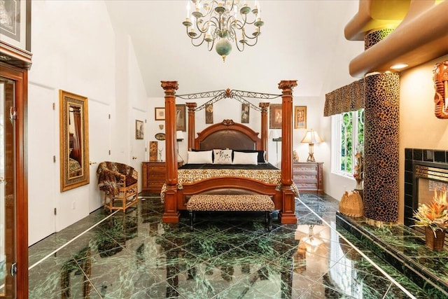 bedroom featuring a high ceiling, an inviting chandelier, and a tiled fireplace