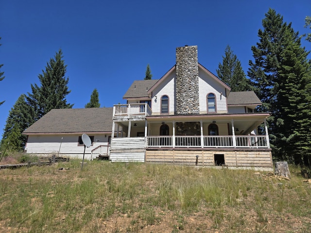 view of front of home featuring covered porch and a balcony