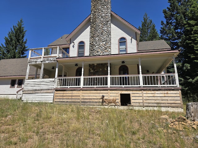 farmhouse inspired home with a porch and a balcony