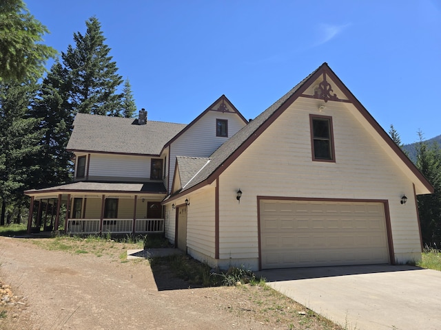 view of front of property with covered porch and a garage