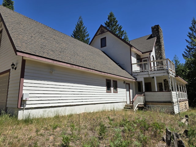 back of property with a balcony