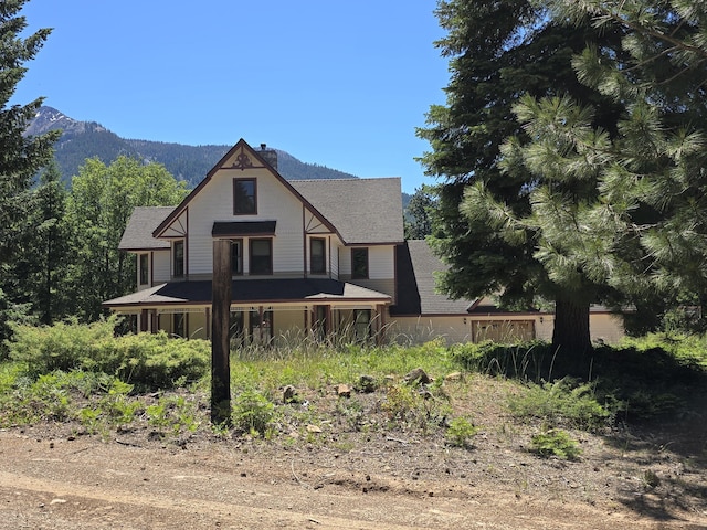 rear view of property featuring a mountain view