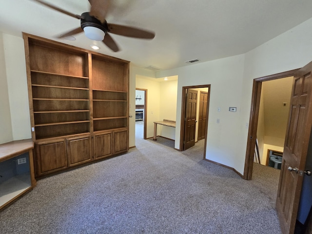 unfurnished living room featuring ceiling fan and light colored carpet