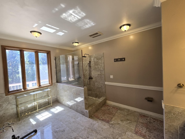 bathroom with crown molding and a tile shower