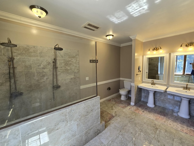 bathroom with a shower, toilet, and ornamental molding