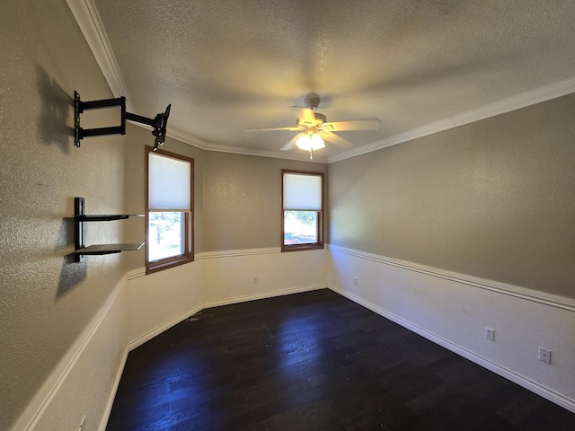 empty room with a textured ceiling, ornamental molding, and dark hardwood / wood-style flooring