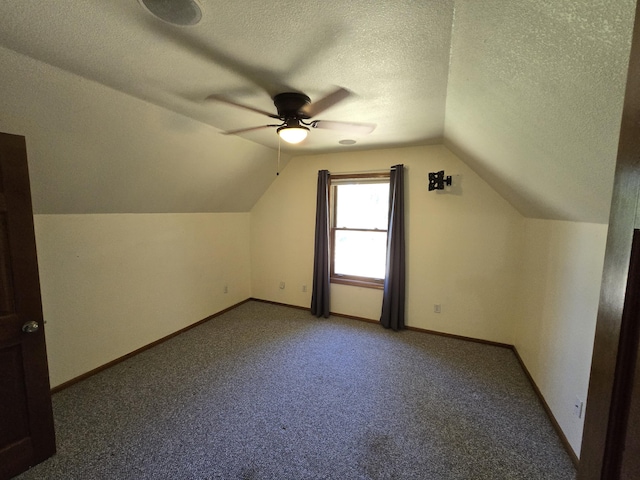 bonus room with ceiling fan, carpet flooring, a textured ceiling, and lofted ceiling