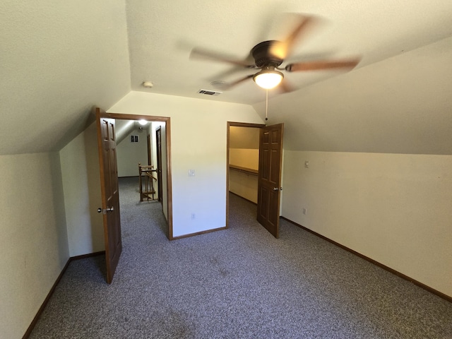 additional living space with carpet flooring, ceiling fan, and vaulted ceiling