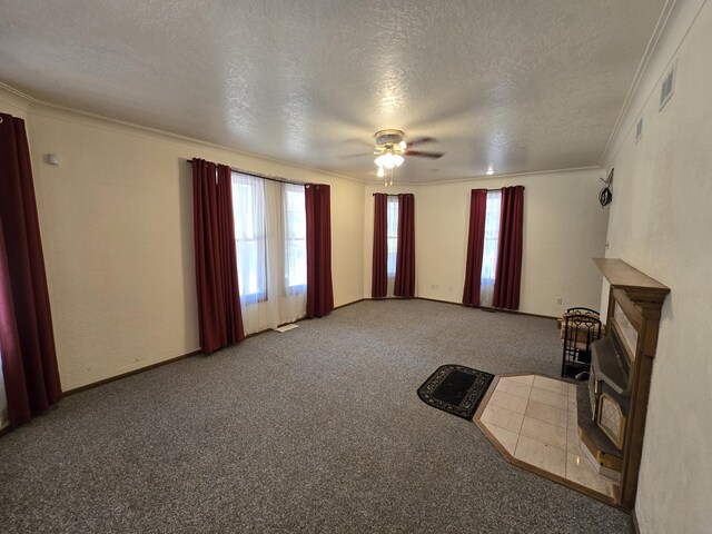 unfurnished living room with carpet flooring, ceiling fan, ornamental molding, and a textured ceiling