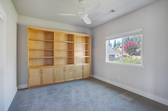 carpeted spare room with ceiling fan