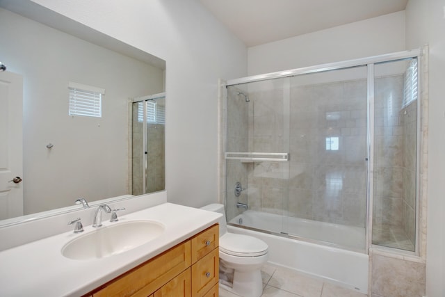 full bathroom featuring shower / bath combination with glass door, tile patterned floors, vanity, and toilet