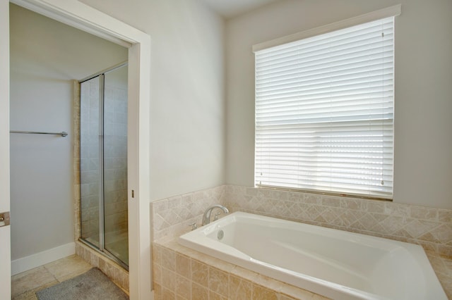 bathroom featuring tile patterned flooring and independent shower and bath