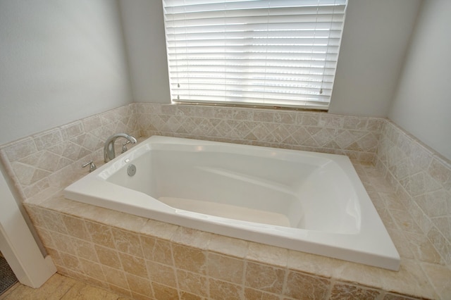 bathroom with a relaxing tiled tub