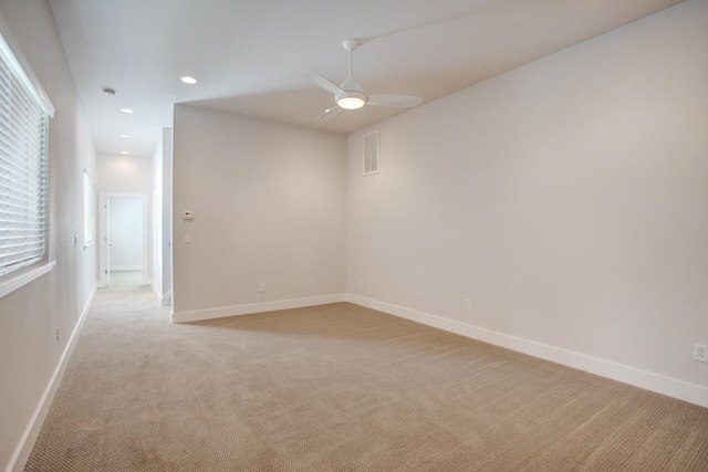 carpeted empty room featuring ceiling fan