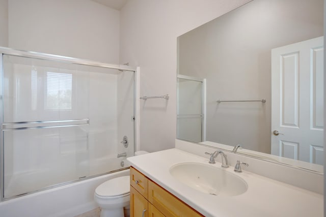 full bathroom featuring shower / bath combination with glass door, vanity, and toilet