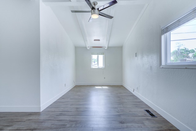 interior space with baseboards, ceiling fan, visible vents, and wood finished floors