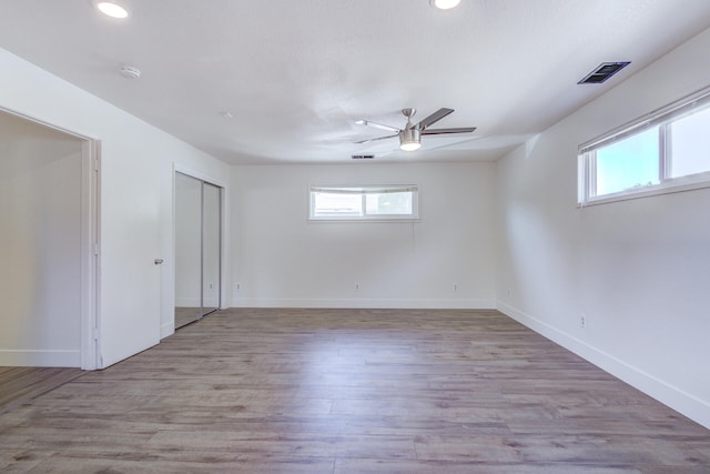 empty room with baseboards, ceiling fan, recessed lighting, and visible vents