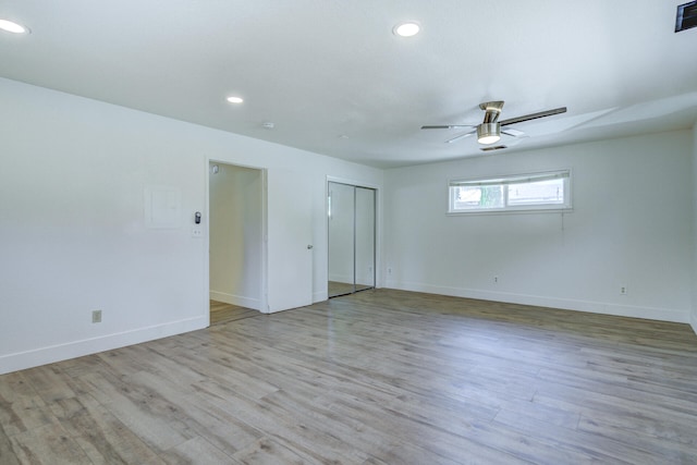 empty room with baseboards, a ceiling fan, recessed lighting, and wood finished floors