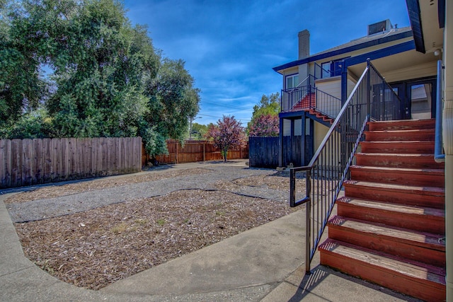 view of yard with stairway and a fenced backyard