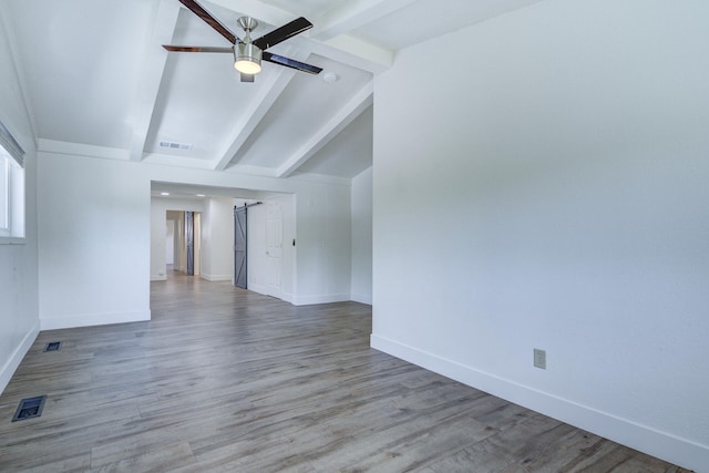 unfurnished room with visible vents, a ceiling fan, baseboards, and vaulted ceiling with beams