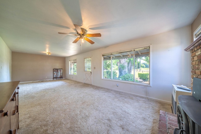 unfurnished living room with ceiling fan and carpet flooring